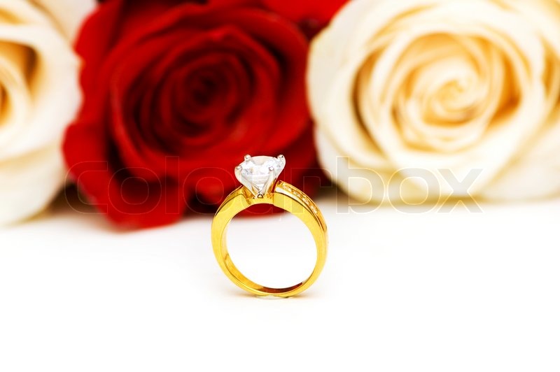 Engagement ring and roses at the background | Stock image | Colourbox