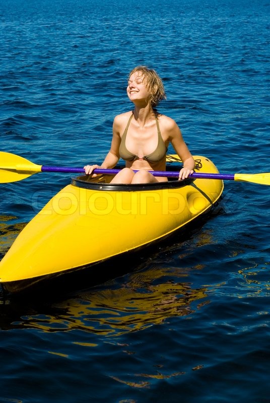 outdoor image with a girl and yellow kayak stock photo colourbox
