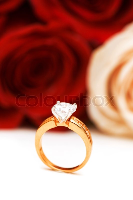 Engagement ring and roses at the background | Stock image | Colourbox