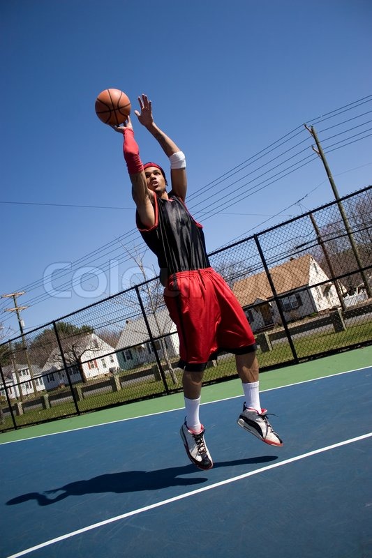 A young basketball player shooting a Stock image Colourbox