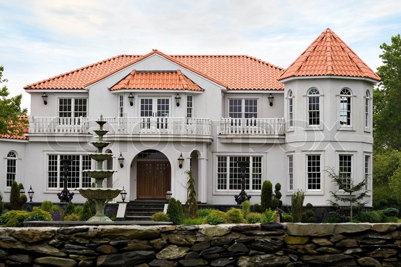 a large mansion with classic architecture and a clay tile roof