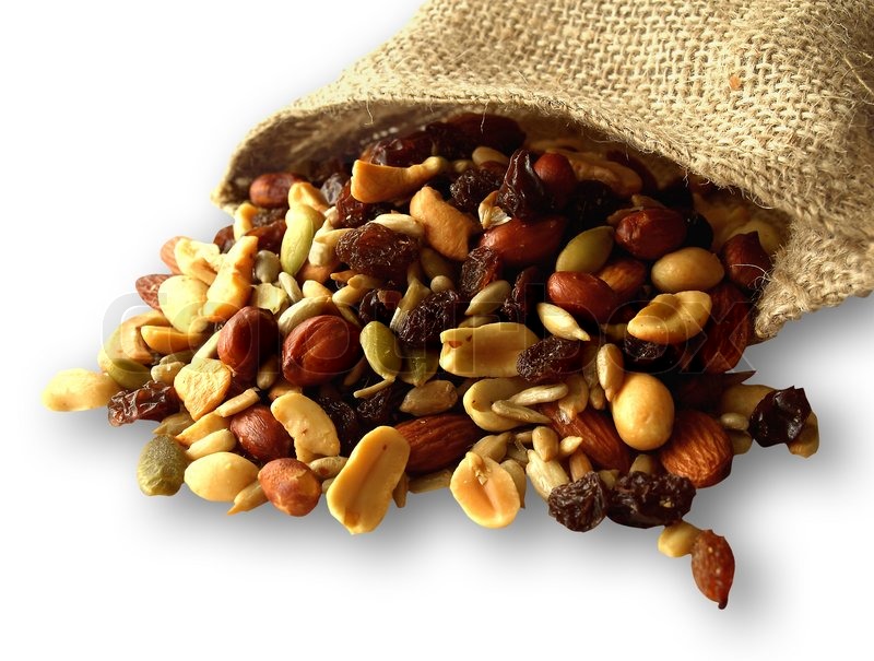 Trail mix of nuts, seeds, and dried fruit on the white background