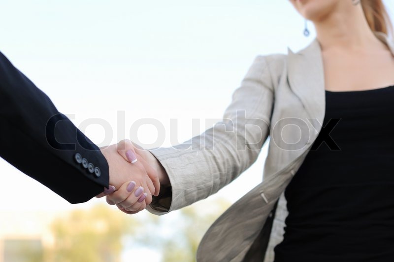 business men and women shaking hands on a light background trust light gg