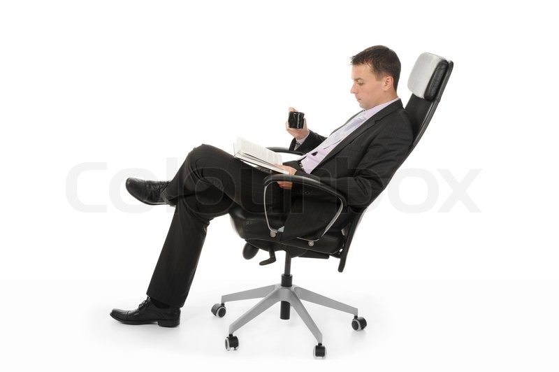Businessman Reading A Book And Drinking Stock Image