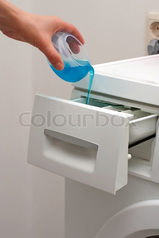 Adding detergent to dispenser of washing machine Stock Photo Colourbox