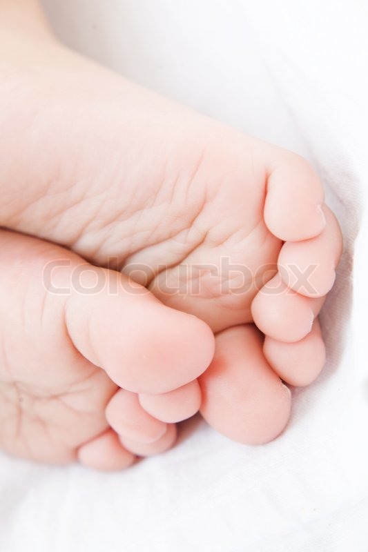 Baby feet closeup on white towel Stock Photo Colourbox