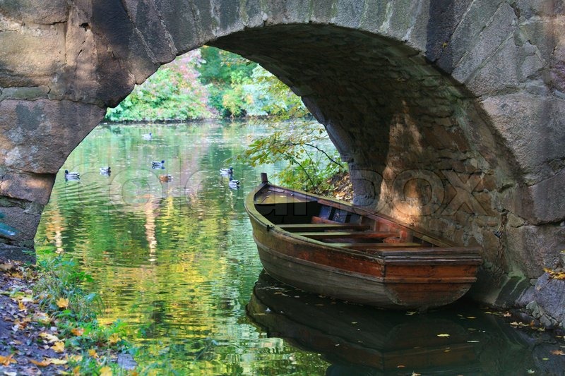 Pond water surface with reflection of colorful trees ...