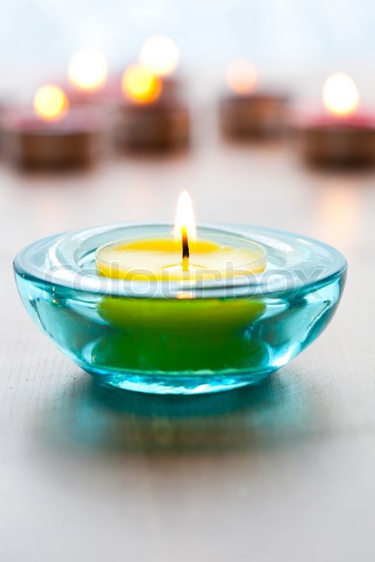 Closeup of yellow candles in blue Stock image Colourbox