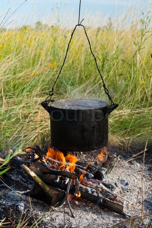 Boiling water in pots above the fire Stock Photo Colourbox
