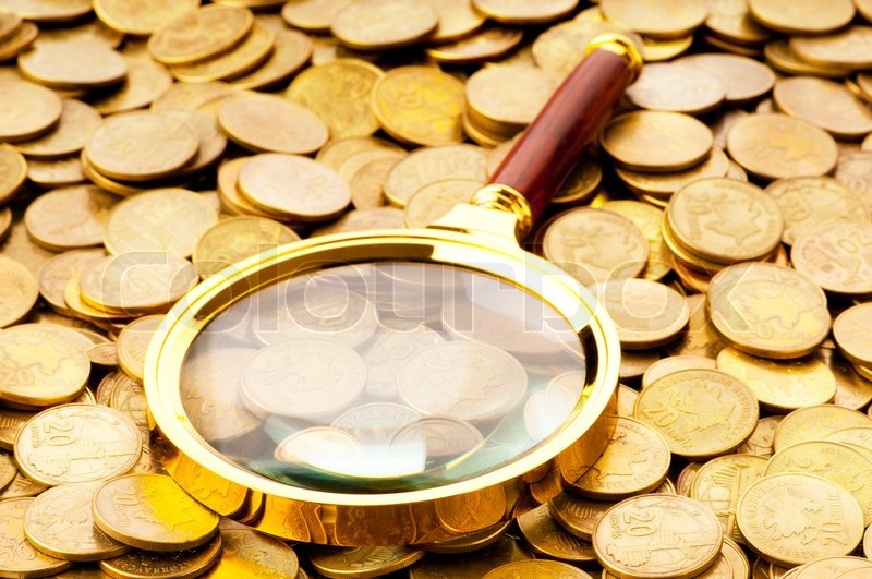 Magnifying glass and coins at the | Stock image | Colourbox