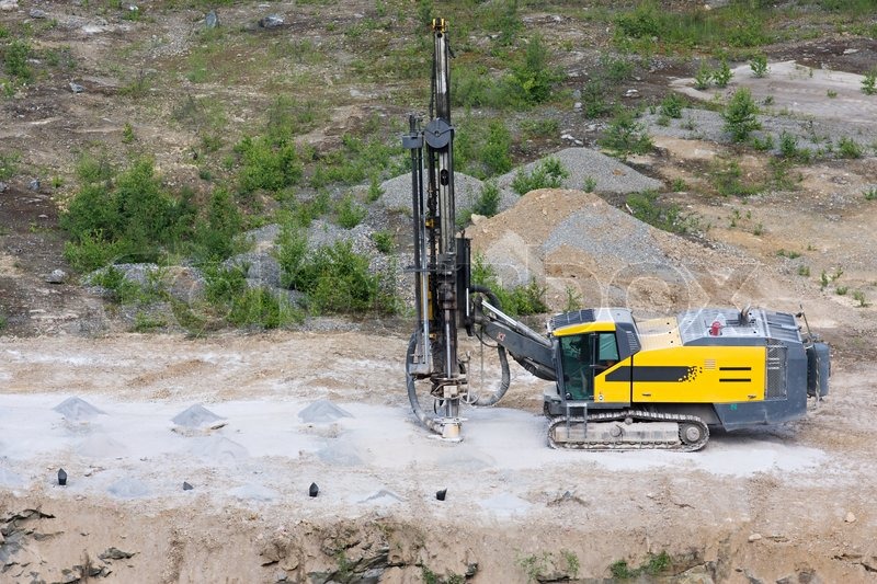 Drilling machine in open cast mining quarry Stock Photo Colourbox