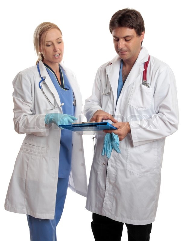 Surgeon and doctor or nurse read over ... | Stock image | Colourbox