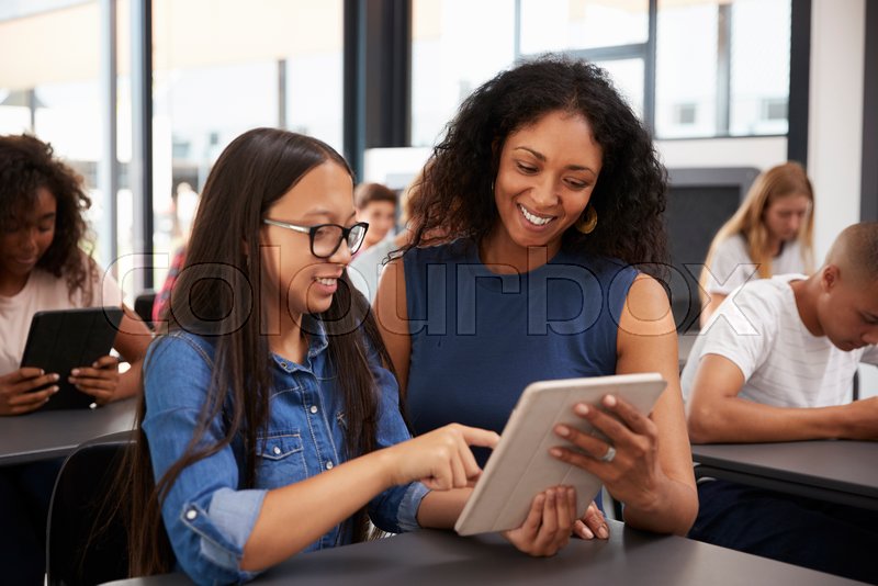 Teacher Helping Teenage Schoolgirl With Tablet Computer Stock Photo Colourbox Teacher Helping Teenage Schoolgirl With Tablet Computer Stock Photo Colourbox