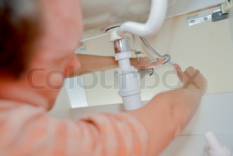 Fixing a broken sink Stock image Colourbox