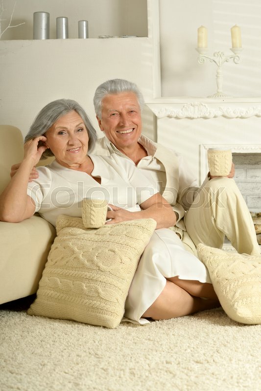 Two Elderly People Sitting At Home On Stock Image Colourbox