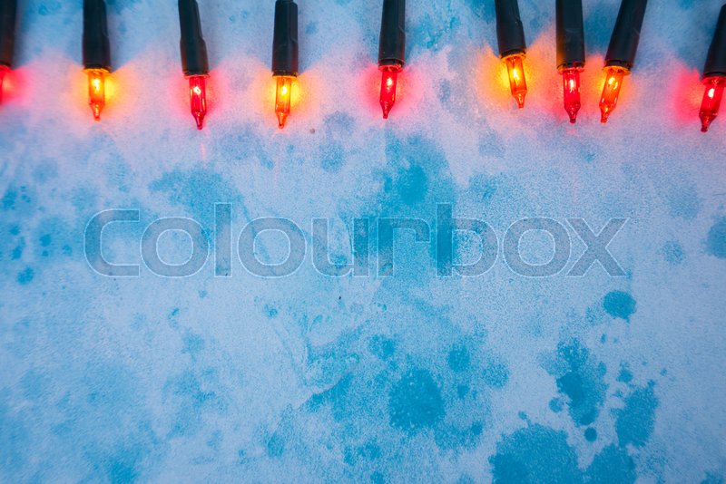 Christmas orange lights on blue | Stock image | Colourbox