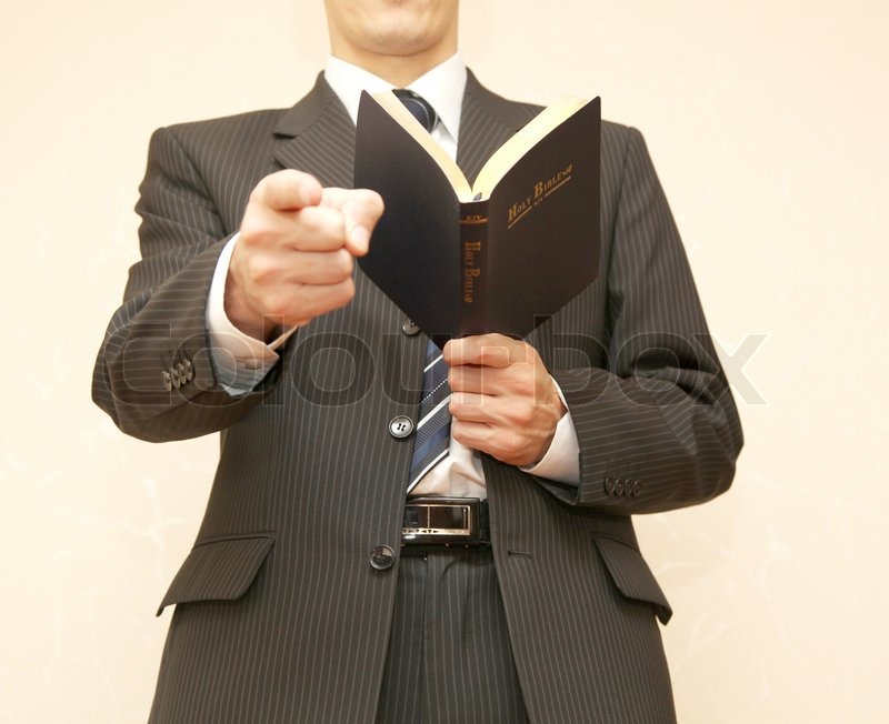 Man in suit with Holy Bible Stock image Colourbox