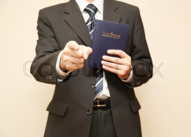 Man in suit with Holy Bible Stock image Colourbox