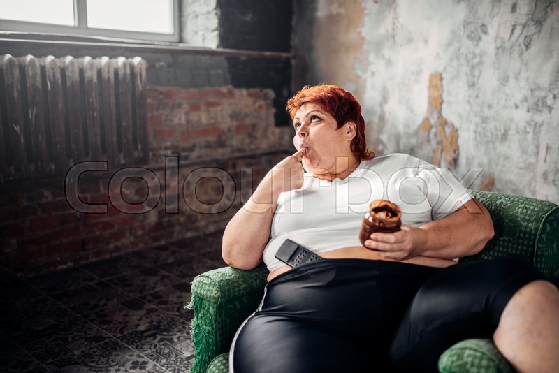 Fat Woman Sits In A Chair And Eats Stock Image Colourbox