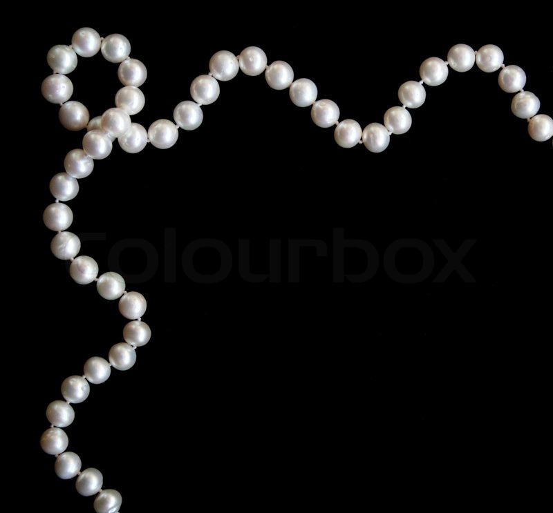 White pearls on the black silk as background, Stock image