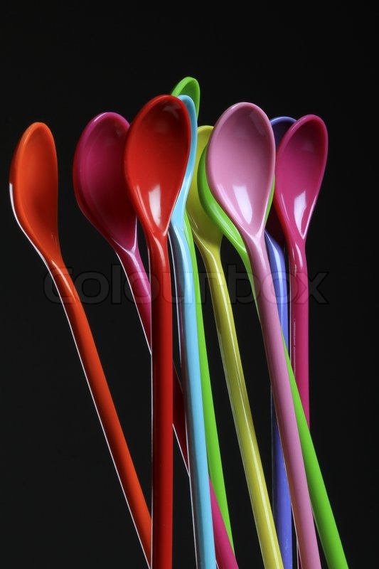 Spoons of different colors on even | Stock image | Colourbox