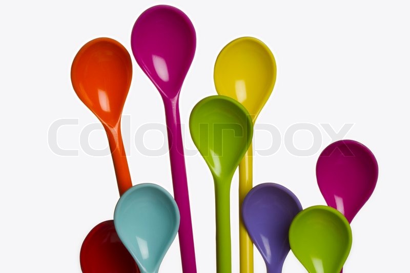 Spoons of different colors on even | Stock image | Colourbox