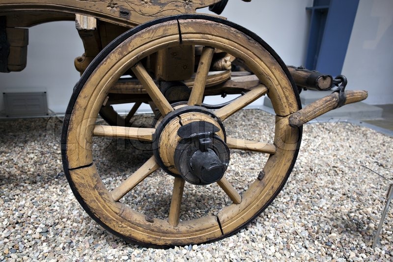 Wheel of a wooden wagon with brake Stock Photo Colourbox