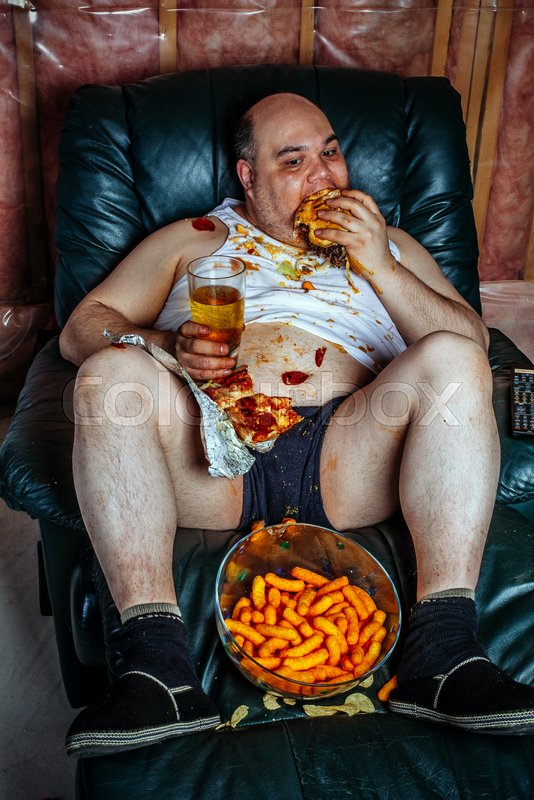 Photo Of A Fat Couch Potato Eating A Stock Image Colourbox