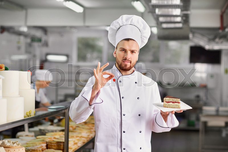 Confectioner with a cake in the bakery. Stock image Colourbox