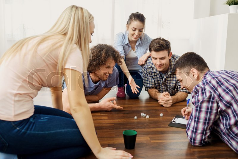 A group of friends play board games on Stock Image Everypixel