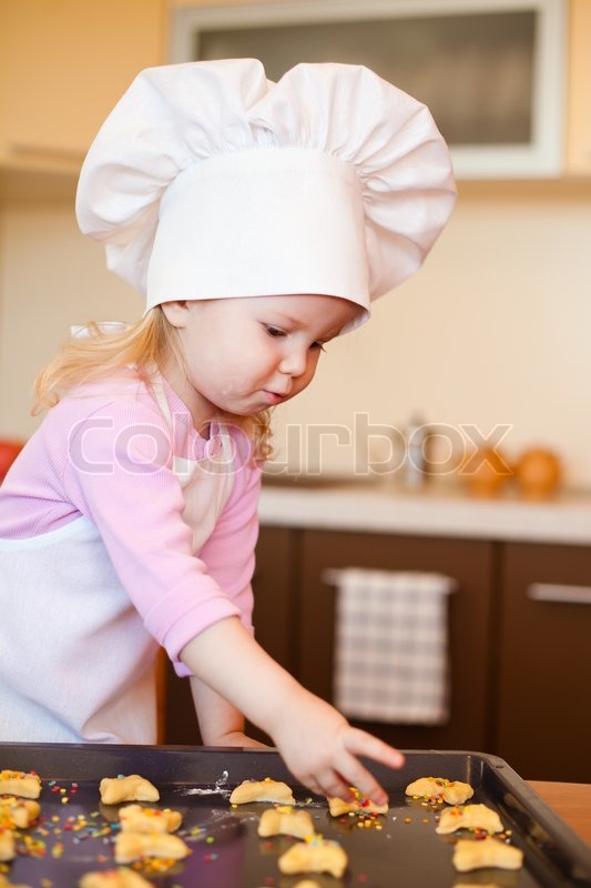 Little girl preparing cookies on ... | Stock image | Colourbox