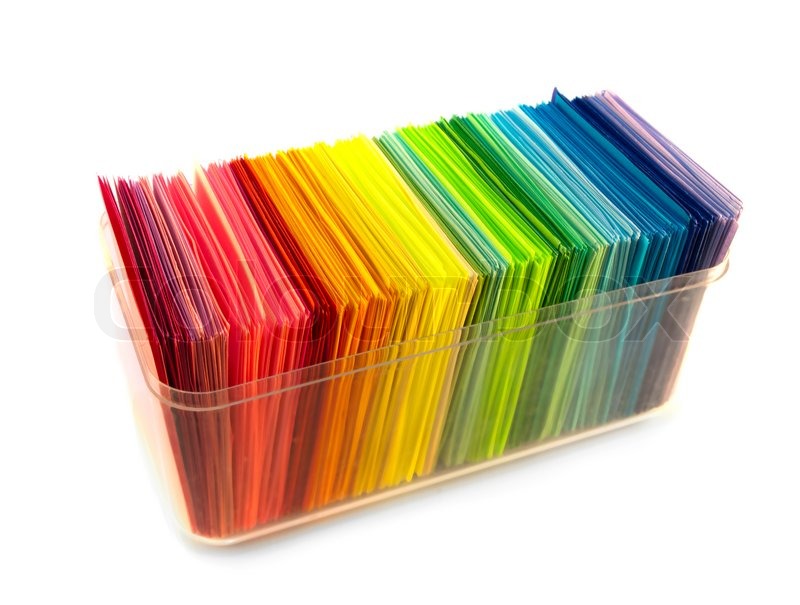 various color paper stack like a rainbow isolated on white stock