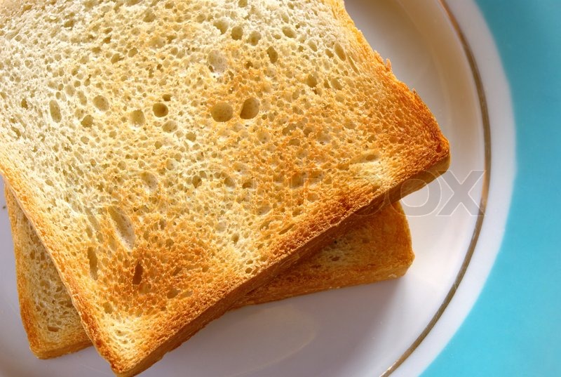 Toasted bread on a plate on the table Stock Photo Colourbox