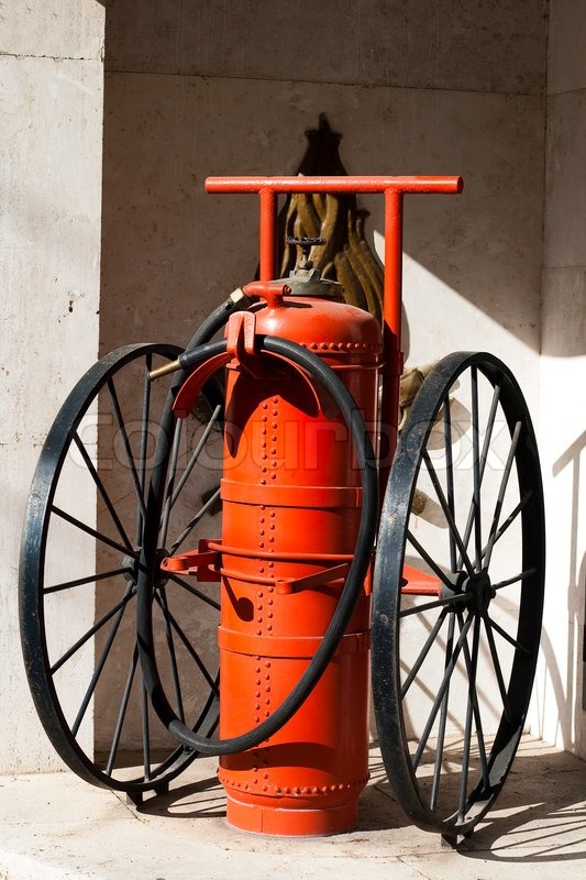 Old big fire extinguisher on the wheels | Stock image | Colourbox