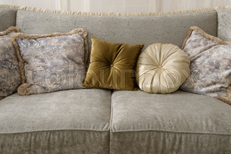 Velvet pillows on grey sofa in room Stock image Colourbox