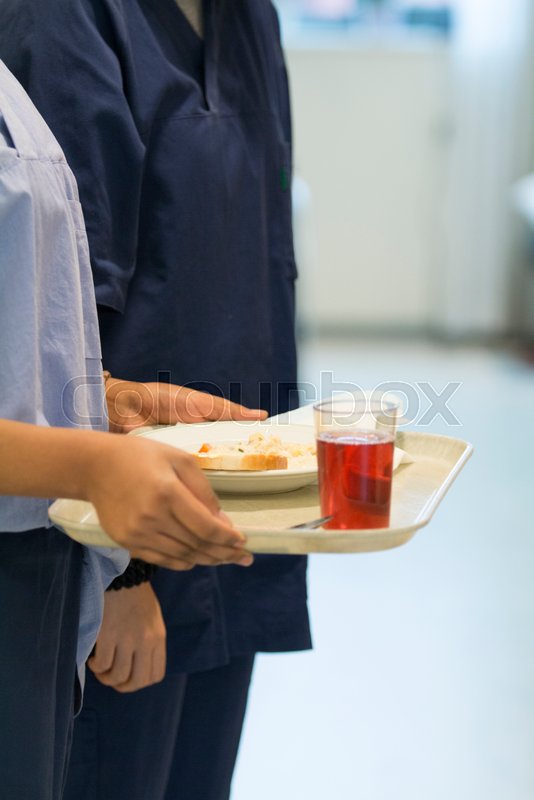 Nurse serving hospital lunch Stock image Colourbox