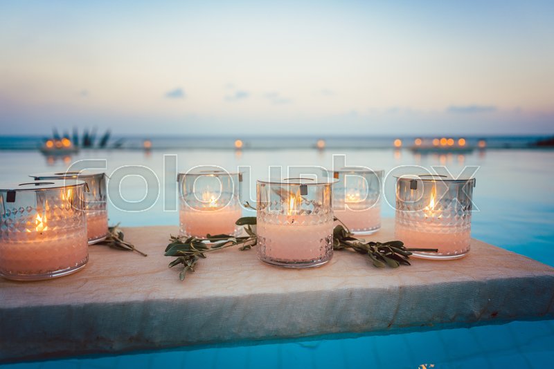 Candles floating in swimming pool at | Stock image | Colourbox