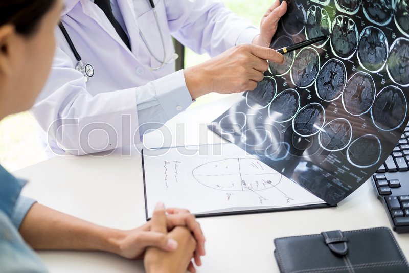 Doctor analyzing a scan or x-ray film ... | Stock image | Colourbox