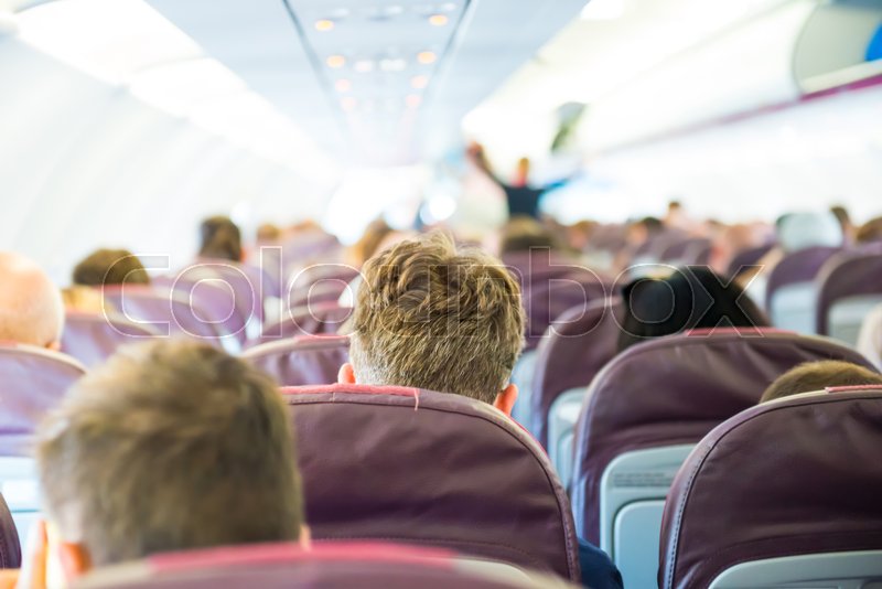 Passengers sit inside airplane people Stock image Colourbox