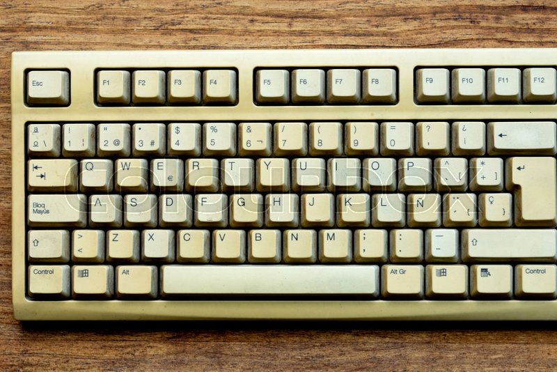 Old keyboard of a computer on a wooden ... | Stock image | Colourbox
