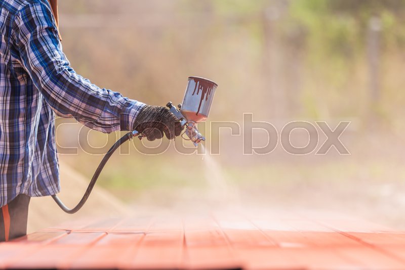 Construction worker spraying paint to Stock image Colourbox