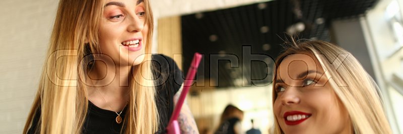 Happy Hairdresser Showing Curling Iron Stock Image Colourbox