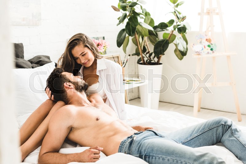 young sexy couple sitting in bed, smiling and looking at each other | Stock image | Colourbox young sexy couple sitting in bed, smiling and looking at each other | Stock image | Colourbox