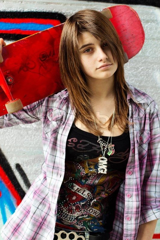 Pretty skater girl holding skateboard | Stock Photo | Colourbox