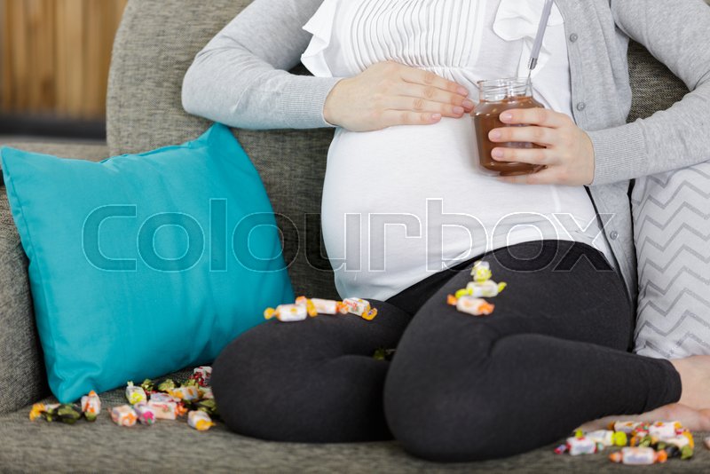 A pregnant woman and chocolate Stock image Colourbox