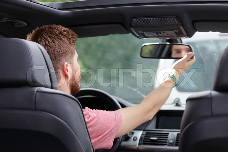 Man checking his car mirror Stock image Colourbox