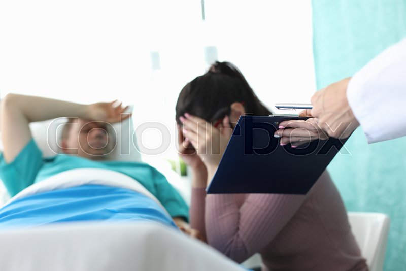 Female doctor brings documents crying | Stock image | Colourbox