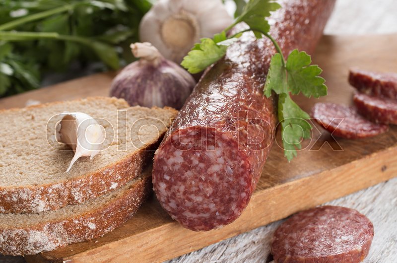 Salami and bread on a wooden board Stock image Colourbox