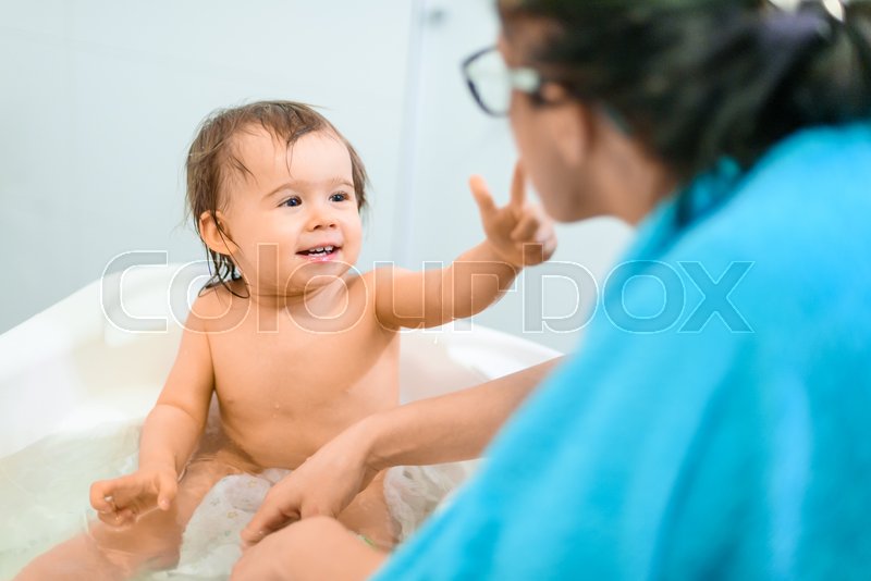 Happy 1 year old Baby in bathtub taking Stock image Colourbox