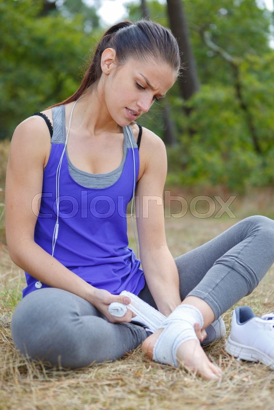 Woman having cramp while running Stock image Colourbox